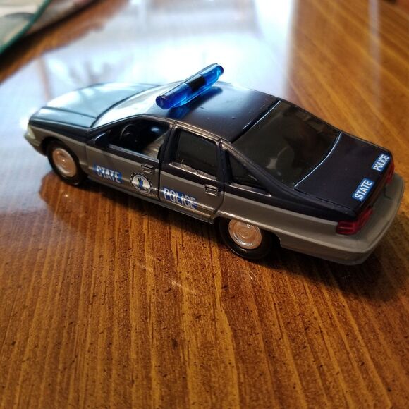 A quantity of large format diecast police cars to include English and